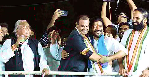TPCC president A Revanth Reddy hugs Bhongir MP Komatireddy Venkat Reddy during a Nirudyoga Nirasana Sabha in Nalgonda.
