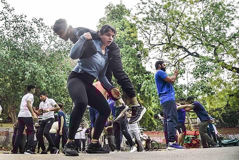 Wrestler Sakshi Malik exercises at Jantar Mantar during wrestlers' protest. ( Photo | PTI )