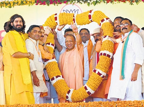 UP CM Yogi Adityanath waves at supporters during a rally in Balrampur. (Photo | Express)