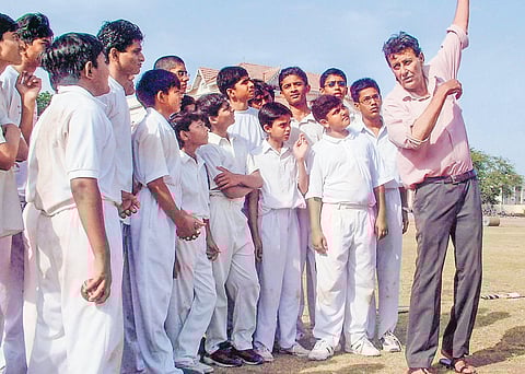 Salim Durani trains budding cricketers at Jamnagar, Gujarat in January 2004. (Inset) He interacts with Anil Kumble at an award function in Mumbai in 2006 | pti