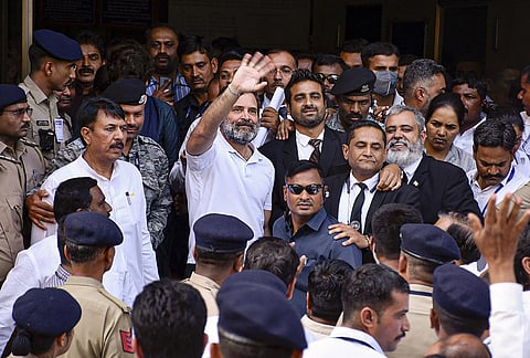 Rahul Gandhi waves at supporters as he leaves from Surat District Court after filing an appeal challenging his conviction and sentencing in the 2019 criminal defamation case. (Photo | PTI)