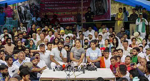 Wrestlers Bajrang Punia, Vinesh Phogat and Sakshi Malik speak with the media during their protest at Jantar Mantar, in New Delhi. (Photo | PTI)