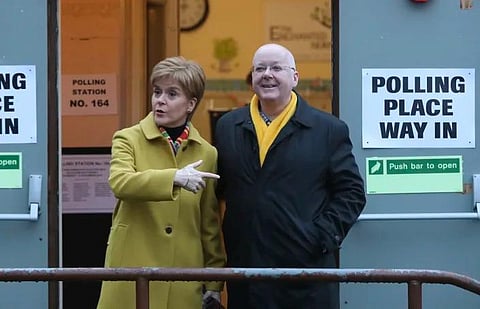 Former Scottish First Minister Nicola Sturgeon with husband Peter Murrell, outside polling station in Glasgow, Scotland, on December 12, 2019. (File Photo | AP)