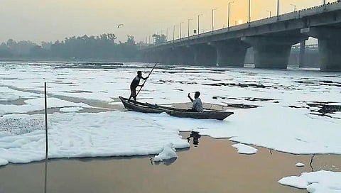 Officials approaches the priests to urge people not to throw waste items in Yamuna