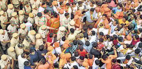 Devotees take part in a procession during Hanuman Jayanti celebrations amid tight security arrangements at Jahangirpuri in New Delhi on Thursday | PTI