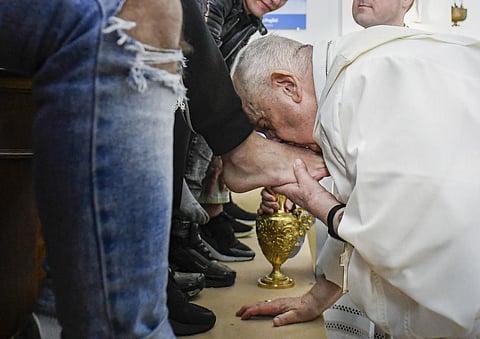Pope Francis kisses the feet of the inmates of Rome's penitentiary of Casal del Marmo, Thursday, April 6, 2023. (Photo | AP)