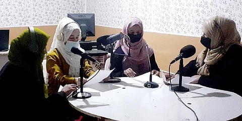 Najia Sorosh head of Sadai Banowan a women-run radio station, right, speaks with her Staff in the broadcasting studio in Badakhshan province. (Photo | AP)