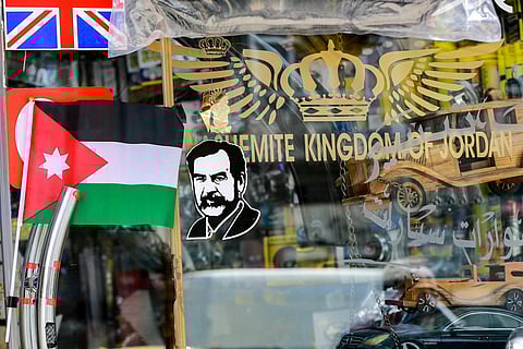 In this picture taken on April 6, 2023, a sticker showing the image of Iraq's late ousted dictator Saddam Hussein is displayed at a bus stop in Amman. (Photo | AFP)