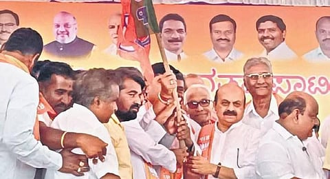 Chief Minister Basavaraj Bommai welcomes new entrants into the BJP fold in Haveri on Friday. (Photo | Express)
