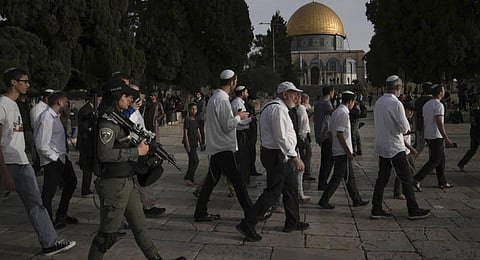 Israeli police escort Jewish visitors marking the holiday pf Passover to the Al-Aqsa Mosque compound. (Photo | AFP)