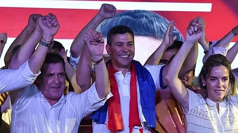 Santiago Peña, centre, celebrates his win with his wife, Leticia Ocampos de Pea, right, and Paraguay’s former president Horacio Cartes (Photo | AFP)