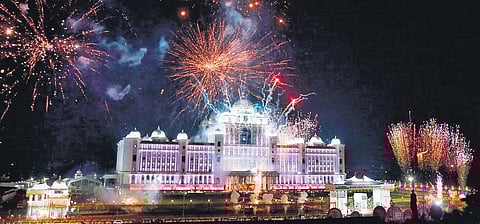 Fireworks illuminate the night sky above the new Secretariat and (below) Chief Minister K Chandrasekhar Rao signs the first file extending the Dalit Bandhu scheme in his chamber on the sixth floor of