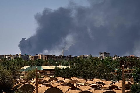 Smoke billows over buildings in Khartoum on May 1, 2023 as deadly clashes between rival generals' forces have entered their third week. (Photo | AFP)