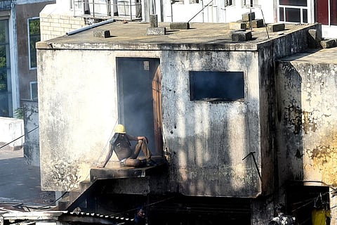 A fire and rescue services personnel catches his breath after putting out the fire at a building near Royapettah. (Photo | P Ravikumar)