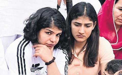 Sakshi Malik and Sangita Phogat at the wrestlers’ protest site at Jantar Mantar, in New Delhi on Sunday. (Photo | Parveen Negi, EPS)