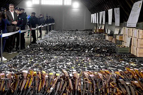 erbian President Aleksandar Vucic, right, inspects weapons collected as part of an amnesty. ( Photo | AP )