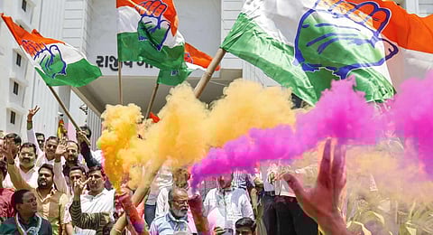 Congress workers celebrate at the party office after the party's decisive lead in the Karnataka Assembly elections. (Photo | PTI)