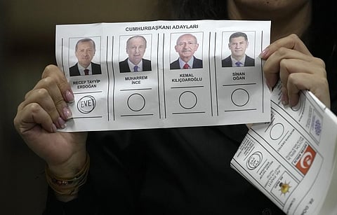 An election representative shows a ballot depicting a vote for President Recep Tayyip Erdogan at a polling station in Istanbul, Turkey, Sunday, May 14, 2023. (Photo | AP)