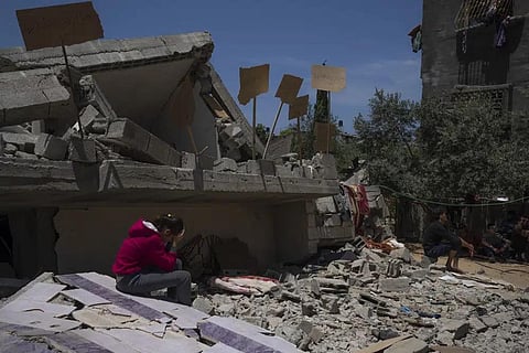 Jalal Nabhan and relatives sit in front of the ruins of their home, which was destroyed in an Israeli airstrike, in Jabaliya, northern Gaza Strip, Sunday, May 14, 2023. (Photo | AP)