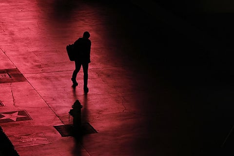 A person walks along the Las Vegas Strip devoid of the usual crowds after casinos have been ordered to shut down due to the coronavirus, March 18, 2020, in Las Vegas. (Photo | AP)