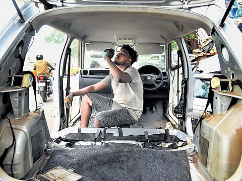A worker at a car scrap workshop takes a breather as the daytime temperature remained over 40 degree Celsius on Monday | P Ravikumar