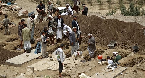 FILE - Yemenis dig graves on April 4, 2015 to bury the victims of a reported airstrike by the Saudi-led coalition against Shiite Huthi rebel positions in the village of Bani Matar. (Photo | AFP)