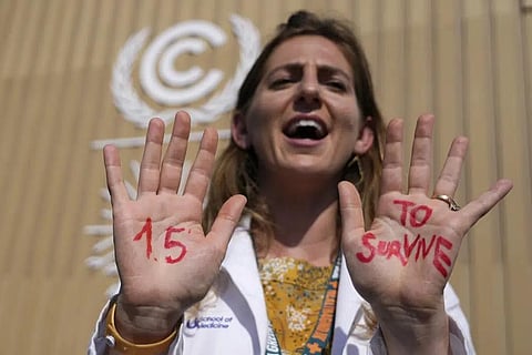 FILE - A demonstrator shows her hands reading '1.5 to survive' at a protest advocating for the warming goal at the COP27 UN Climate Summit, Nov 16, 2022, in Sharm el-Sheikh, Egypt. (Photo | AP)