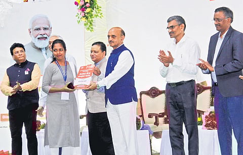 Union Minister of State for Finance Bhagwat Kishanrao Karad hands over appointment order to a candidate at the 5th Rozgar Mela in Visakhapatnam on Tuesday I G Satyanarayana