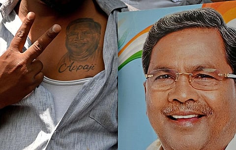 A supporter of Congress leader Siddaramaiah shows a victory sign, near his residence in Bengaluru. (Photo | Shashidhar Byrappa, EPS)