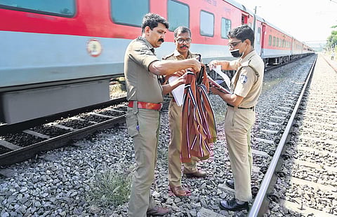 FILE: Police examining a bag found near the arson site in Elathur. (Photo | E Gokul)