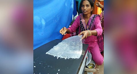 A woman making rice sheets on themachine developed by RARS at NG Ranga Agricultural University. (Photo | Express)