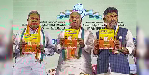Congress President Mallikarjun Kharge with KPCC President DK Shivakumar and former CM Siddaramaiah releases the party's manifesto in Bengaluru, May 2, 2023. (Photo | PTI)