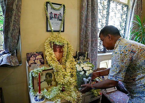 A man pays floral tribute to legendary filmmaker Satyajit Ray on the occasion of his birth anniversary, at his residence in Kolkata, on May 2, 2023. (Photo | PTI)