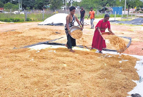 Farmers dry soaked paddy in Jangaon district on Monday