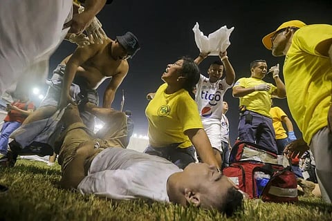 Rescuers attend an injured fan lying on the field of the Cuscatlan stadium in San Salvador, El Salvador, Saturday, May 20, 2023. (Photo | AP)