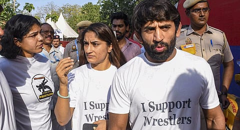 Wrestlers Vinesh Phogat, Bajrang Punia and Sakshi Malik outside Arun Jaitley Stadium during the IPL 2023 cricket match between Delhi Capitals and Chennai Super Kings.(Photo | PTI)