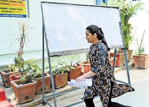 A student runs towards the entrance of an examination centre of the Common Entrance Test in Bengaluru on Sunday | Nagaraja Gadekal