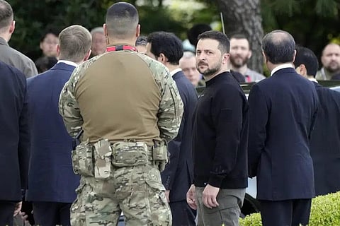 Volodymyr Zelenskyy, center front, waits for a car after laying flowers in front of the Cenotaph for the Victims of the Atomic Bomb at the Hiroshima Peace Memorial Park. (Photo | AP)