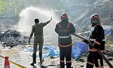 Fire and Rescue Services officials pumping water in an attempt to douse the fire that erupted in the warehouse of Kerala Medical Services Corporation Ltd at KINFRA park in Menamkulam in the early hour