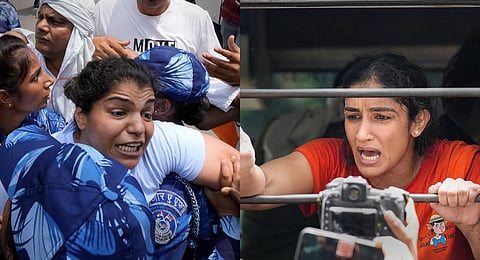 Police detain wrestlers Sakshi Malik (L) & Sangeeta Phogat (R) during their protest march towards the new Parliament building, in New Delhi, on May 28, 2023. (Photo | PTI)