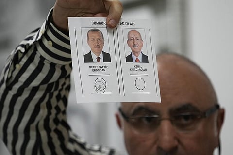 An election representative shows a ballot with a vote for the Turkish President Recep Tayyip Erdogan, at a polling station in Istanbul, Turkey, Sunday, May 28, 2023. (Photo | AP)