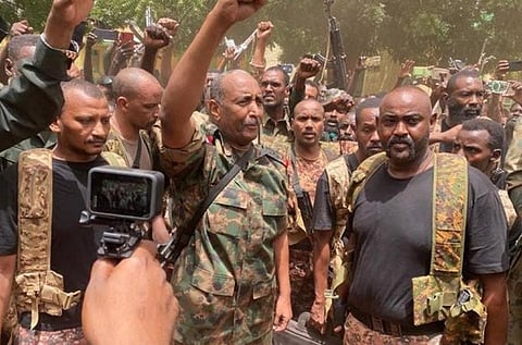 This pic released on the Sudanese Army s Facebook page on May 30, 2023, shows army chief Abdel Fattah al-Burhan cheering with soldiers as he visits some of their positions in Khartoum. (Photo | AFP)