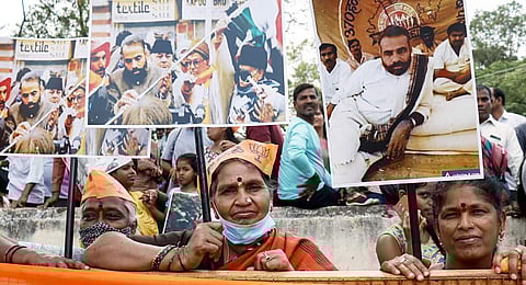 BJP supporters during a roadshow of Prime Minister Narendra Modi (unseen) ahead of Karnataka Assembly elections, in Mysore on Sunday. (File Photo | ANI)