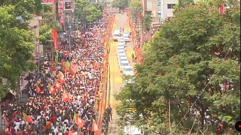 BJP supporters during a roadshow by Prime Minister Narendra Modi for the Karnataka Assembly elections, in Tumakuru on Friday. (Photo | Special Arrangement)