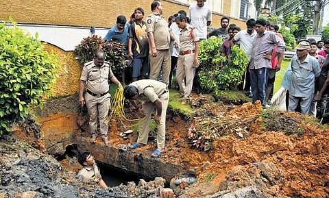 Police carrying out a rescue operation after T Abhiram slipped into an overflowing open drain at Gurunanak Colony in Vijayawada on Friday | Prasant Madugula