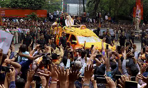 Prime Minister Narendra Modi waves at supporters during a roadshow ahead of Karnataka Assembly elections, in Bengaluru. (Photo | Shashidhar Byrappa)