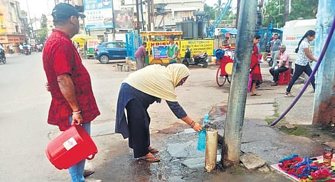 Locals collecting drinking water from a stand post near Tinikonia Bagicha | Express