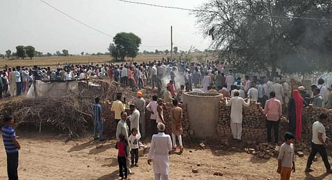 : Locals gather after a MiG-21 fighter aircraft of the Indian Air Force (IAF) crashed in Hanumangarh district, Monday, May 8, 2023. At least two civilians were killed in the incident. (Photo | PTI)