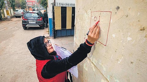 An enumerator marks a house during the caste survey in Patna in January. (Photo | PTI)