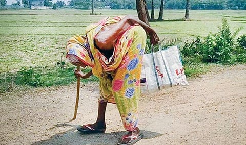 Nonagenarian Kali Jena on way to collect PDS rice in Binjharpur block on Sunday